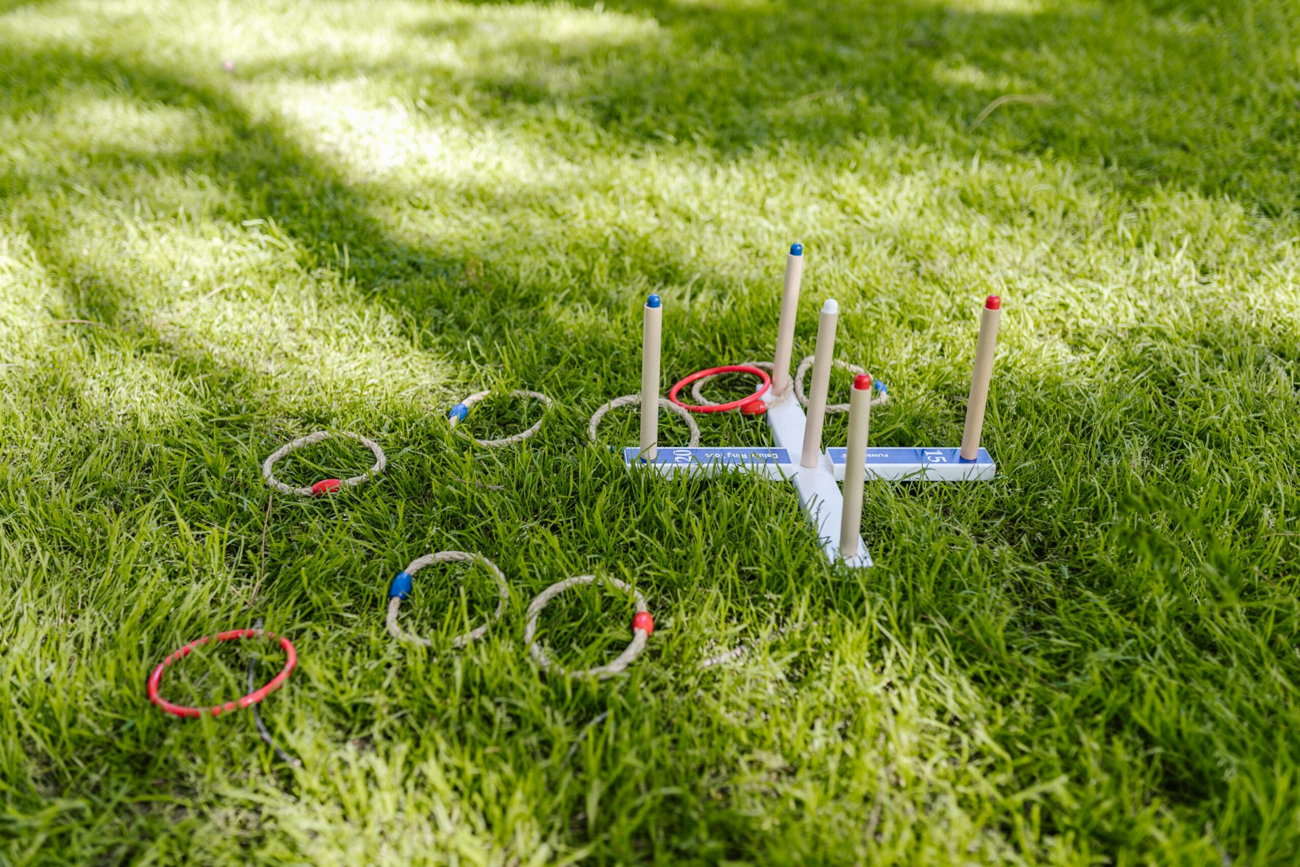 Vibrant outdoor ring toss game set on lush green grass, perfect for summer fun.